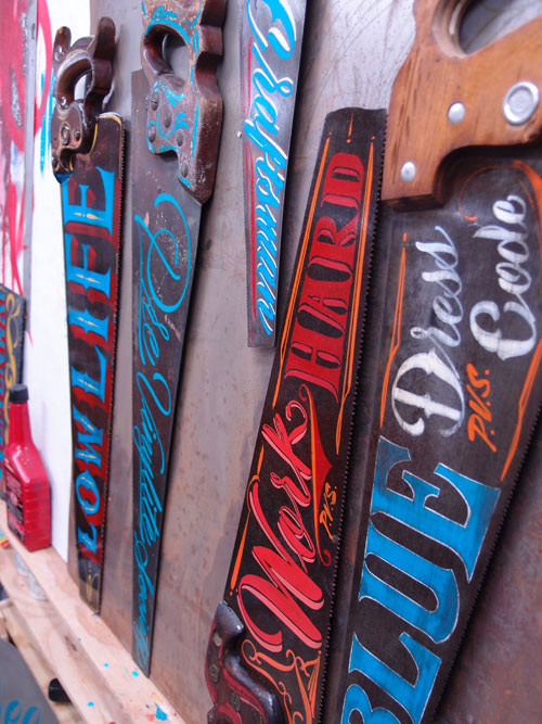 Hand-painted signs on antique saws by Kenji Nakayama